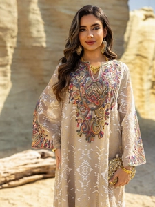 Detailed close-up of intricate colorful embroidery and sequins on ethnic kaftan dress