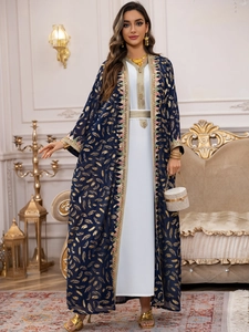 Détail du cardigan bleu marine avec imprimés plumes dorées et broderies fines