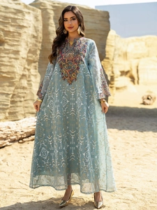 Detailed view of the intricate multi-color embroidery on a light turquoise mesh maxi dress