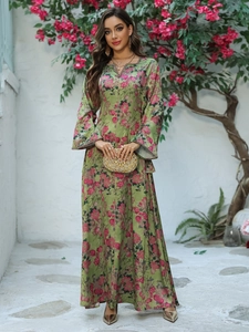 Detail of elegant floral long sleeve kaftan dress with V-neck and printed flower pattern