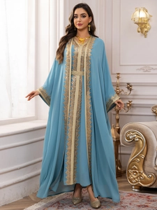 Close-up of golden lace embroidery and sequin details on light blue chiffon kaftan