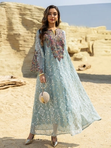 Close-up of intricate embroidery on light blue kaftan dress sleeves and neckline