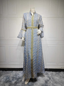 Detailed embroidery on light blue kaftan dress with bell sleeves and metallic leaf patterns