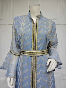 Detailed leaf embroidery on a light blue flared sleeve kaftan dress displayed on a mannequin