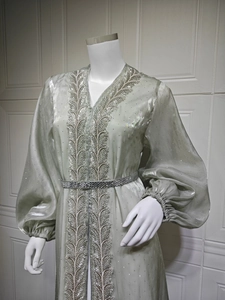 Detailed embroidery and rhinestone belt on an elegant light green kaftan gown