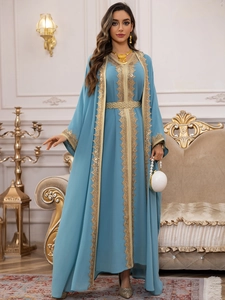Detailed embroidery and sequins on a blue chiffon maxi dress with a golden belt