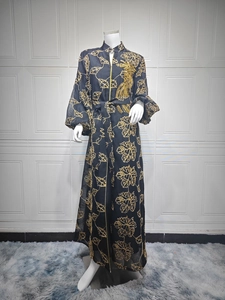 Detail of black Jalabiya dress with gold leaf patterns and sequin bird embroidery