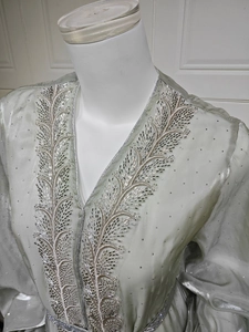Detailed view of silver embroidery and beads on a V-neck puff sleeve maxi cardigan dress