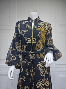 Detailed view of the 3D gold phoenix beadwork and embroidery on this black Jalabiya dress