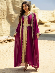 Detail of purple kaftan with gold lace embroidery and woven belt in desert setting
