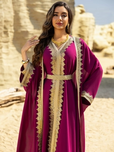 Detailed embroidery and gold lace ribbon on a purple chiffon kaftan dress with belt