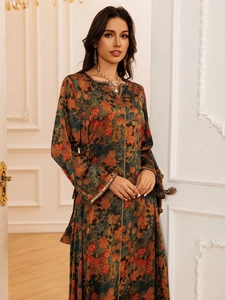 Detail of bohemian floral print dress with golden woven trim on sleeves and neckline