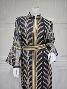 Detailed embroidery of gold leaves on long-sleeve black dress with flared cuffs