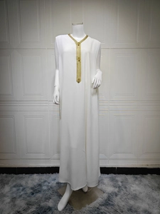 Détails de broderie dorée sur une robe longue sans manches en mousseline blanche kaftan