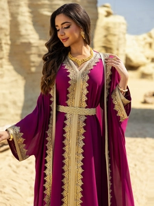 Detail of deep purple kaftan featuring intricate gold vine embroidery and woven belt