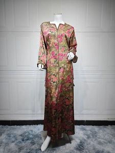 Detail of V-neck floral printed maxi dress showing fabric texture and golden trim detail