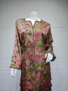 Detail of floral printed maxi dress featuring golden bead embroidery on the V-neckline