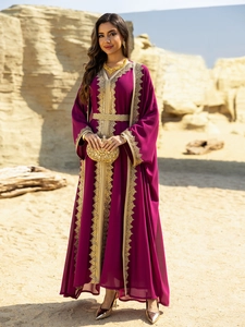 Detail of dark purple chiffon kaftan with intricate gold embroidery and woven belt