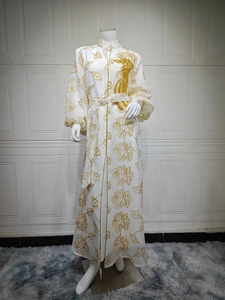 Detailed view of the heavy gold sequin embroidery on this elegant white Jalabiya gown