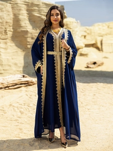 Detail of gold lace embroidery on dark blue chiffon kaftan dress with braided belt