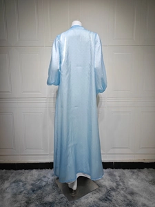 Detailed back view of light blue maxi dress with subtle shimmer and elegant puffy sleeves