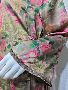 Close-up of floral print sleeve with decorative black sequin scalloped edge detail
