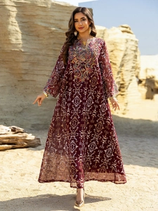 Detailed view of intricate ethnic embroidery on the neckline of the deep red maxi dress