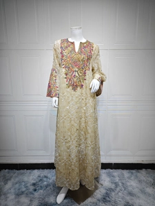 Detail of colorful embroidery on the neckline of a beige mesh embroidered maxi dress