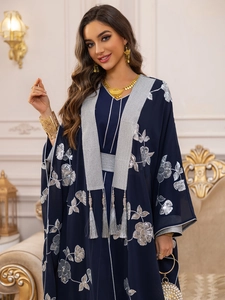 Détail du caftan bleu marine avec broderie florale argentée et garnitures à franges