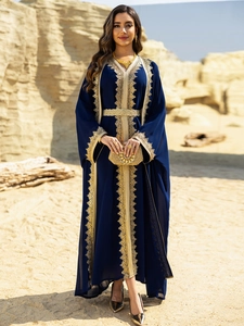 Close-up of golden lace embroidery and matching belt on a navy blue chiffon dress