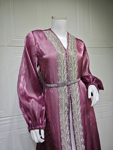 Detail of silver leaf embroidery and rhinestones on deep purple puff sleeve gown