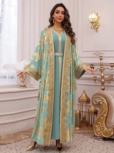 Detail of mint green two-piece maxi dress with gold floral embroidery and sequin trim