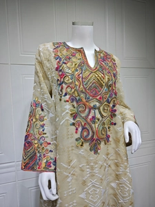 Detailed close-up of intricate mesh embroidery and sequins on the neckline of this dress