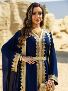 Detail of navy blue chiffon abaya featuring golden lace embroidery and braided belt