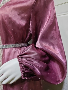 Detail of purple satin abaya with sparkling rhinestones and crystal belt on the waist
