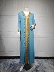 Detailed view of golden embroidery on light blue chiffon V-neck kaftan sleeve and neckline