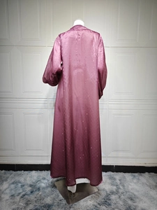 Rear view of puff sleeve plum maxi dress showing glossy fabric with subtle glitter finish