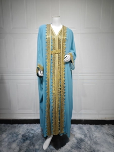 Detail of gold embroidery and lace trim on the sky blue chiffon long sleeve dress