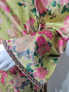 Close-up of floral print dress with beaded rhinestone trim and woven cuff details
