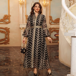 Elegant black and gold embroidered maxi dress with flared sleeves and matching waist belt