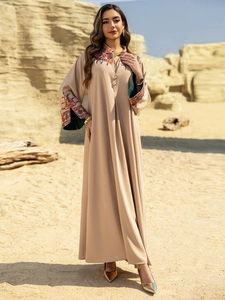 Exquisite floral embroidery detail on neckline and sleeves of apricot kaftan maxi dress