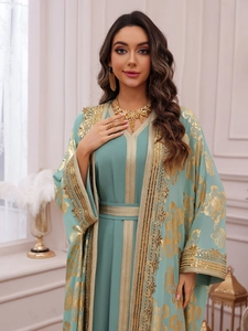 Detailed embroidery and sequins on mint green kaftan with golden floral patterns