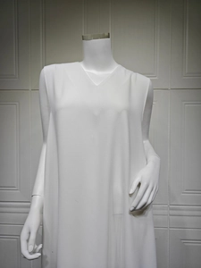 Detail of elegant white V-neck sleeveless dress with smooth premium texture and loose fit