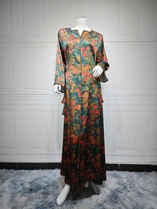 Detail of the V-neckline with shiny bead trim on the orange floral long sleeve dress