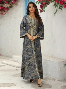 Detail of dark blue Kaftan dress featuring gold baroque embroidery and bell sleeves