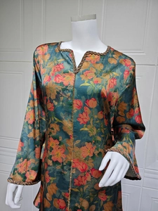 Detail of floral printed maxi dress with gold beaded trim and soft satin texture