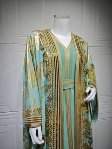Detail of mint green Kaftan with gold jacquard, sequin embroidery and fringe trim