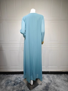 Back view of light blue chiffon maxi dress featuring gold embroidered cuffs and long sleeves