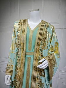 Close-up of golden floral embroidery and sequins on the mint green kaftan dress sleeves