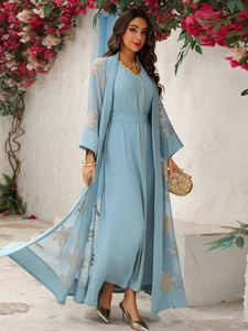Detail of light blue dress set with gold palm tree embroidery and sheer tulle kaftan